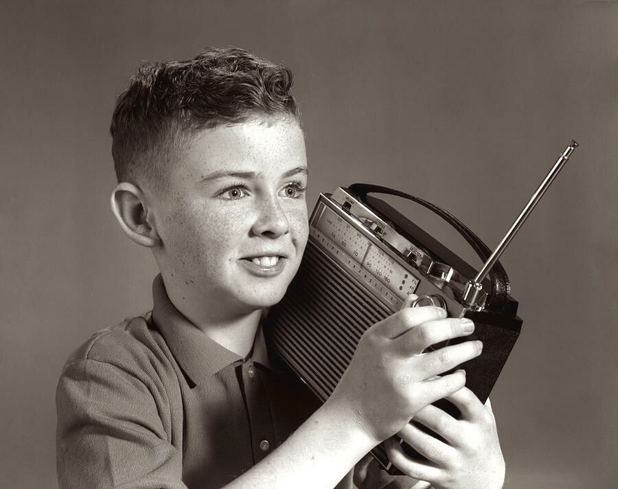 1960s-boy-listening-to-portable-radio-vintage-images